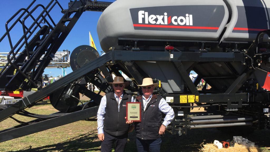 Steve Mulder holding an award for Best New Release standing in front of the Flex-Coil display at the Dowerin GWN7 Machinery Field Days